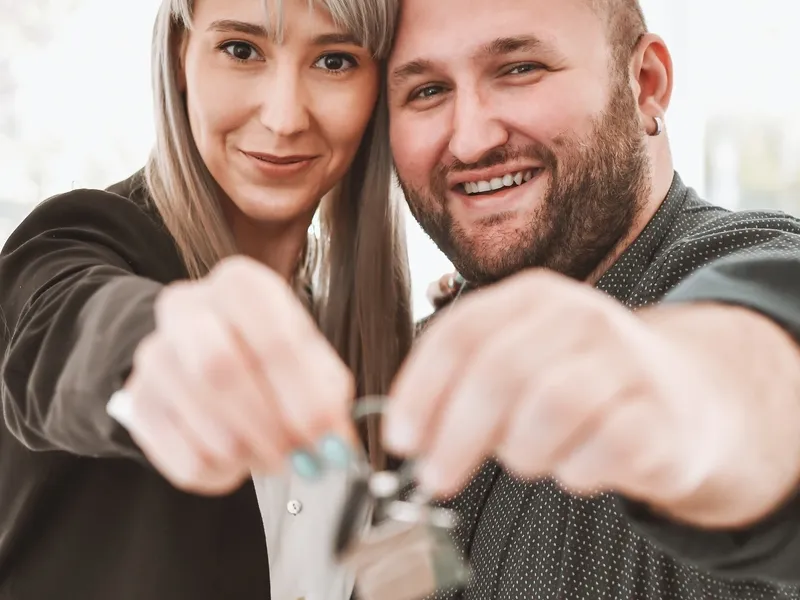 A couple holding the keys to a home